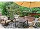 Outdoor patio featuring comfortable seating around a brick fire pit and mature landscaping at 50 S Eudora St, Denver, CO 80246