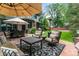 Spacious patio with a dining area, lounge seating, and a lush green lawn at 50 S Eudora St, Denver, CO 80246