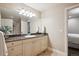 Clean bathroom featuring granite countertop, vanity, and a large mirror at 50 S Eudora St, Denver, CO 80246