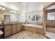Luxurious bathroom showcases a soaking tub, tiled shower, and vanity, creating a spa-like experience at 50 S Eudora St, Denver, CO 80246