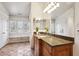 Well-lit bathroom includes a large vanity, tile flooring, and ample storage, providing a functional and stylish space at 50 S Eudora St, Denver, CO 80246