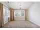 Large bedroom with a large window, shutters, elegant curtains, neutral carpet, and chandelier at 50 S Eudora St, Denver, CO 80246