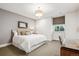 Comfortable bedroom featuring a queen bed, desk, and large window with patterned blinds at 50 S Eudora St, Denver, CO 80246