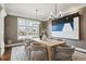 Formal dining room with an oversized window, hardwood floors, and modern chandelier at 50 S Eudora St, Denver, CO 80246