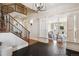 Elegant foyer showcasing a staircase with iron railings and views into the living room at 50 S Eudora St, Denver, CO 80246