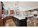 Open kitchen with a large island, dark cabinets, hardwood floors, and an open floor plan at 50 S Eudora St, Denver, CO 80246