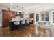 Spacious kitchen featuring a large center island, dark cabinetry, and an adjacent dining area at 50 S Eudora St, Denver, CO 80246