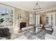 Cozy living room featuring a stone fireplace, bright windows, and comfortable seating at 50 S Eudora St, Denver, CO 80246
