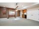 Finished basement with a wet bar and wood cabinets, textured walls, and recessed lighting at 50 S Eudora St, Denver, CO 80246