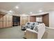Finished basement living room featuring built-in cabinets, plush seating, and recessed lighting at 50 S Eudora St, Denver, CO 80246