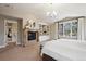 Cozy main bedroom boasts a fireplace, built-in shelving, and large windows for ample natural light at 50 S Eudora St, Denver, CO 80246