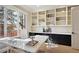 Home office featuring built-in bookshelves and cabinets, and a light and airy ambiance at 50 S Eudora St, Denver, CO 80246