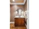 Elegant powder room featuring a wooden vanity and designer lighting fixtures at 50 S Eudora St, Denver, CO 80246