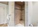 Modern shower featuring tiled walls, a glass door, and built-in seating, offering a spa-like experience at 50 S Eudora St, Denver, CO 80246