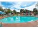 Exterior view of a large community pool with seating and a clubhouse at 12543 W Alameda Dr, Lakewood, CO 80228