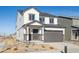 Two-story home with gray siding, white accents, and a two-car garage at 1273 Bloom St, Brighton, CO 80601