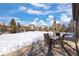Spacious backyard with patio furniture and a large snow-covered lawn at 1021 Neptunite Pl, Castle Rock, CO 80108