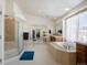 Bright bathroom featuring a soaking tub, separate glass shower, and dual vanity sinks, offering a spa-like retreat at 1021 Neptunite Pl, Castle Rock, CO 80108