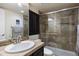 Modern bathroom featuring a glass enclosed tiled shower, vanity sink, and neutral color scheme for a sleek and inviting space at 1021 Neptunite Pl, Castle Rock, CO 80108
