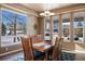 Spacious dining area with large windows and a wooden dining table at 1021 Neptunite Pl, Castle Rock, CO 80108