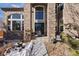 Two-story house entrance with brick facade and walkway at 1021 Neptunite Pl, Castle Rock, CO 80108