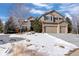 Two-story house with attached garage and snow-covered lawn at 1021 Neptunite Pl, Castle Rock, CO 80108