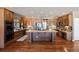 Large kitchen featuring a central island, stainless steel appliances, and custom wood cabinetry at 1021 Neptunite Pl, Castle Rock, CO 80108