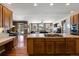 Open kitchen with an island, stainless steel appliances, and seamless flow to the living area at 1021 Neptunite Pl, Castle Rock, CO 80108