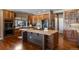 Well-appointed kitchen with wood cabinetry, center island, and modern appliances at 1021 Neptunite Pl, Castle Rock, CO 80108
