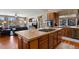 Open kitchen with island, gas cooktop, and views into the living room at 1021 Neptunite Pl, Castle Rock, CO 80108
