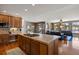 Kitchen island with gas cooktop and breakfast bar overlooking the living room at 1021 Neptunite Pl, Castle Rock, CO 80108