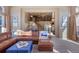 Cozy living room showcasing a curved staircase and a comfortable leather sectional sofa at 1021 Neptunite Pl, Castle Rock, CO 80108