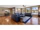 Open living room with hardwood floors, ample seating, and access to adjacent dining area at 1021 Neptunite Pl, Castle Rock, CO 80108