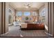 Spacious living room with large windows and a comfortable leather sectional at 1021 Neptunite Pl, Castle Rock, CO 80108