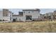 A spacious backyard featuring a patio area, manicured lawn, and modern architecture at 12345 Festival Ln, Thornton, CO 80241
