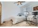 Bright bedroom featuring a ceiling fan, window with blinds, and a comfortable sleeping and working space at 12345 Festival Ln, Thornton, CO 80241