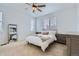Cozy bedroom with soft lighting, large window, and neutral decor at 12345 Festival Ln, Thornton, CO 80241