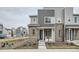Modern townhome featuring mixed siding, stone accents, and a charming front porch offering stylish curb appeal at 12345 Festival Ln, Thornton, CO 80241