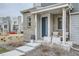 Inviting front porch with blue door, brick accents, and patio seating on well-maintained property at 12345 Festival Ln, Thornton, CO 80241