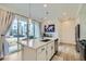 Kitchen island with counter seating, modern lighting, and stainless steel appliances at 12345 Festival Ln, Thornton, CO 80241