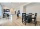 Modern kitchen open to living area boasts stainless appliances, island seating and adjacent dining at 12345 Festival Ln, Thornton, CO 80241