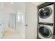Upstairs hallway with a stackable washer and dryer at 12345 Festival Ln, Thornton, CO 80241