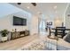 Spacious living area seamlessly connecting to the kitchen and dining area, ideal for entertaining at 12345 Festival Ln, Thornton, CO 80241