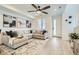 Cozy living room featuring neutral decor, a large sectional, and ample natural light at 12345 Festival Ln, Thornton, CO 80241