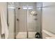 Glass enclosed shower with a rainfall shower head and built in storage at 12345 Festival Ln, Thornton, CO 80241