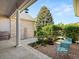 A cozy back patio features a small outdoor dining set and a charming gravel area surrounded by lush greenery at 10631 Clarke Farms Dr, Parker, CO 80134