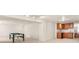 Finished basement area with a pool table, white walls and a kitchenette area with oak cabinets at 10631 Clarke Farms Dr, Parker, CO 80134