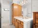 A light and bright bathroom with storage cabinets above the sink at 10631 Clarke Farms Dr, Parker, CO 80134
