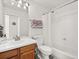 Clean bathroom featuring a shower/tub combo, white tile, and a wooden vanity at 10631 Clarke Farms Dr, Parker, CO 80134