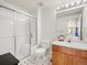 Bright bathroom with a tiled shower, glass door, and wood vanity at 10631 Clarke Farms Dr, Parker, CO 80134